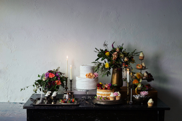 Wedding sweet table inspired by Dutch masters still lifes. Dark shadows, window light, grain, shallow depth of field.